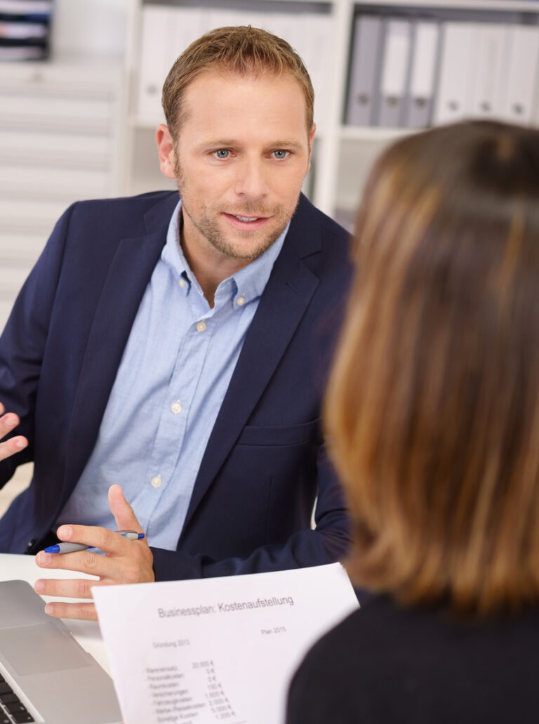 Businessman discussing strategy with a BQPM consultant.